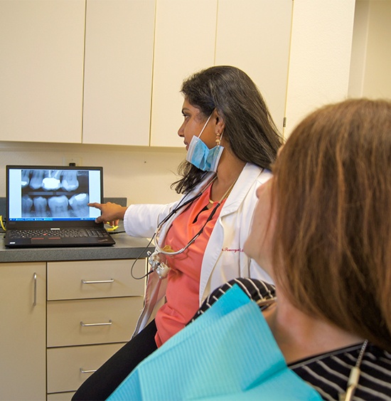 dentist showing x-ray to patient