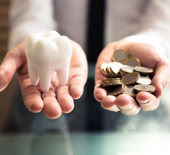 Hands holding tooth and coins for cost of wisdom tooth removal in Rockledge