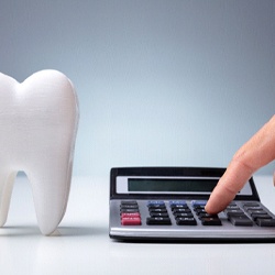 model tooth and calculator representing cost of wisdom tooth removal in Rockledge