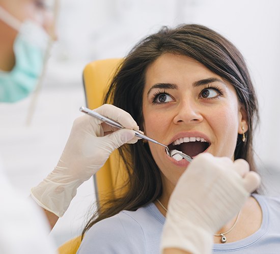 dentist examining woman's smile