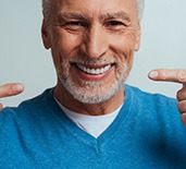 An older man pleased with his dentures