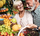 An older couple buying healthy foods from a super market