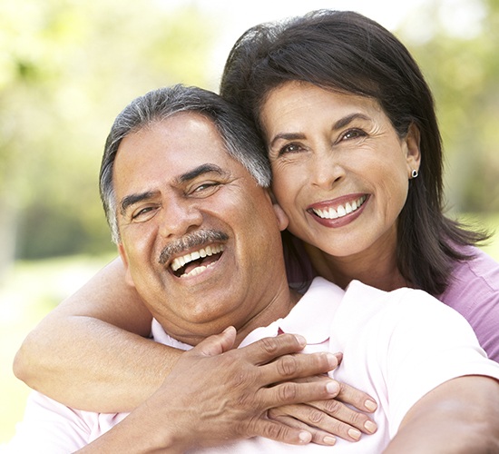 wife hugging husband and smiling