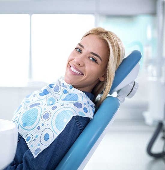 Woman in dental chair for cosmetic dentistry.