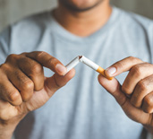 Closeup of patient breaking cigarette