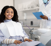 Woman smiling while sitting in treatment chair
