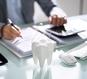 Patient using calculator to look into cost of dental emergencies