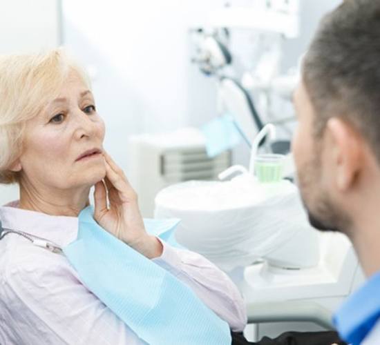 woman with a dental emergency in Rockledge talking to her dentist 