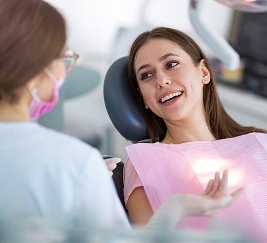 woman talking to her implant dentist in Rockledge 