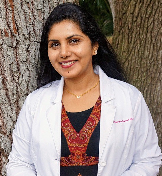 Rockledge Dentist, Dr. Kumar in front of tree