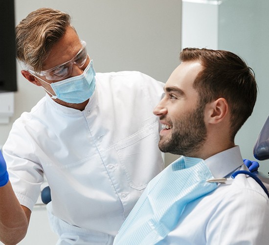 A dentist discussing tooth-colored fillings in Rockledge with a male patient