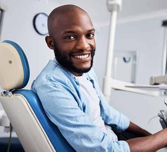 Male dental patient looking to side and smiling