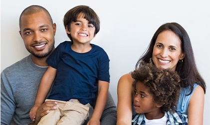 Diverse family of four smiling