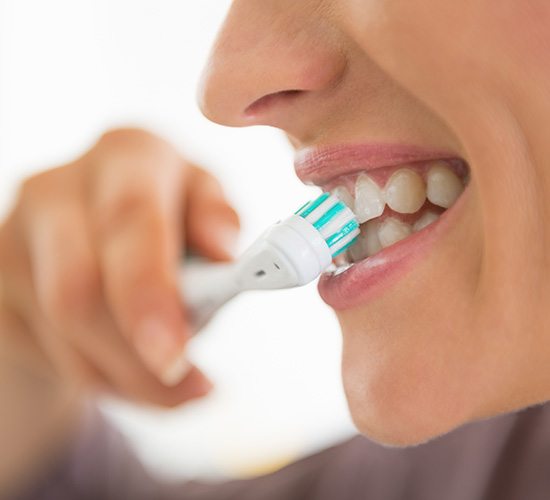 woman brushing teeth