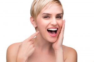 Woman pointing to her white smile