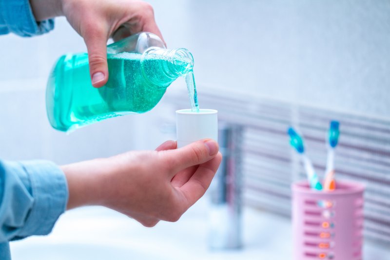Person using mouthwash from dentist in Rockledge