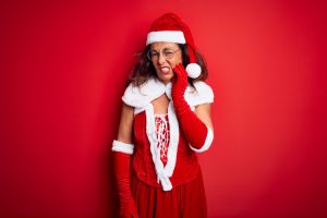 woman in Santa costume with toothache