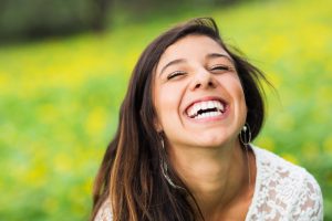 young woman laughing outdoors