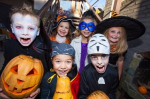 A group of children dressed in Halloween costumes.