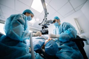 Dentist performing dental implant surgery.